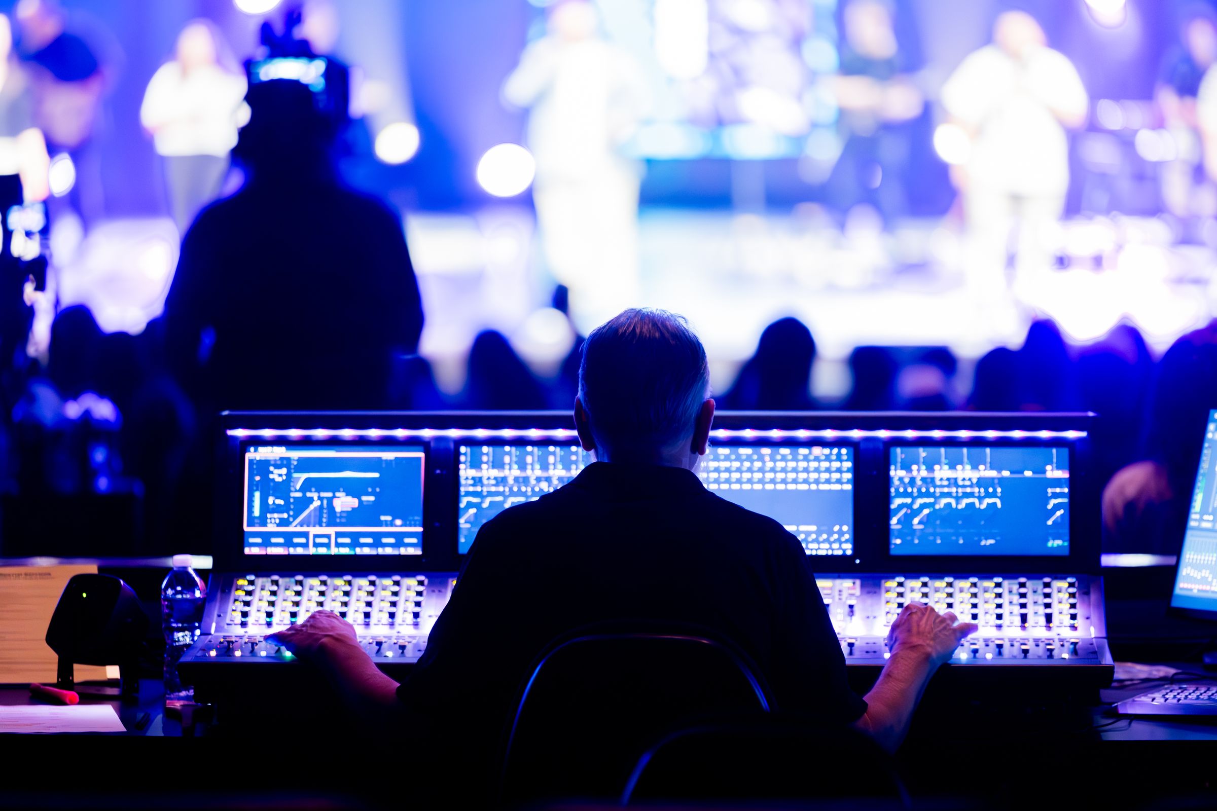 Sound engineer working at a front-of-house console during a live show